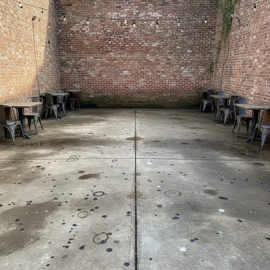 A Spokane restaurant patio with grimy, gum-stained concrete before pressure washing